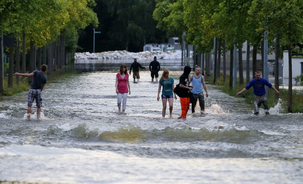 People walk through flooded street in Magdeburg