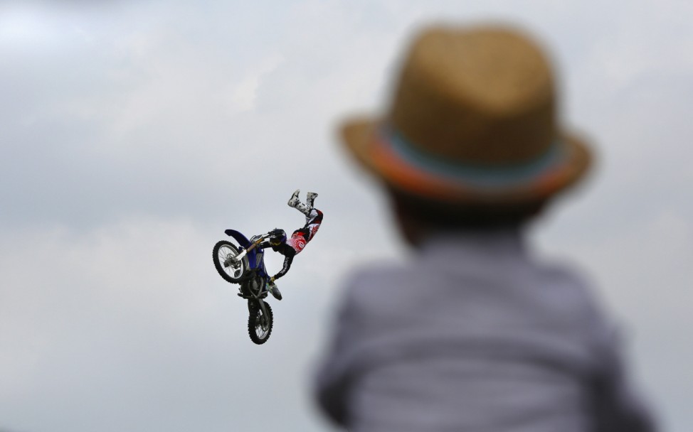 A competitor performs at the Moto Mega Ramp competition during the 2013 X-Games at Jiangwan Stadium in Shanghai