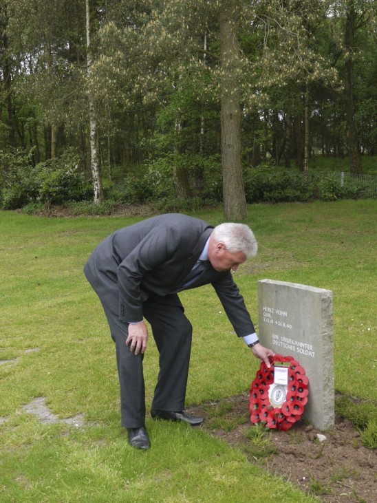 Royal Air Force Museum handout photo shows RAF Museum Cosford General Manager Medhurst laying a wreath at the tombstone of German Luftwaffe Cpl Heinz Huhn at Cannock Chase German war cemetery in Cannock