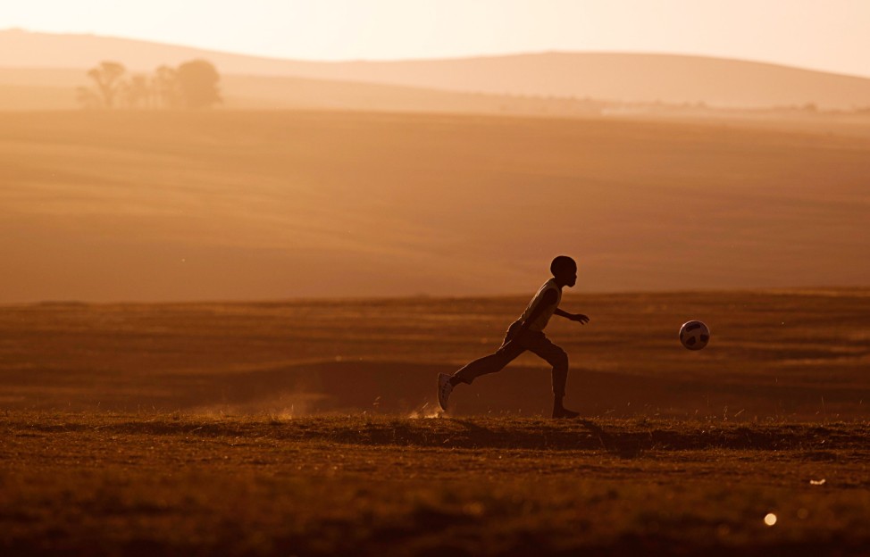 A child plays soccer near former South African President Nelson Mandela's house in Qunu