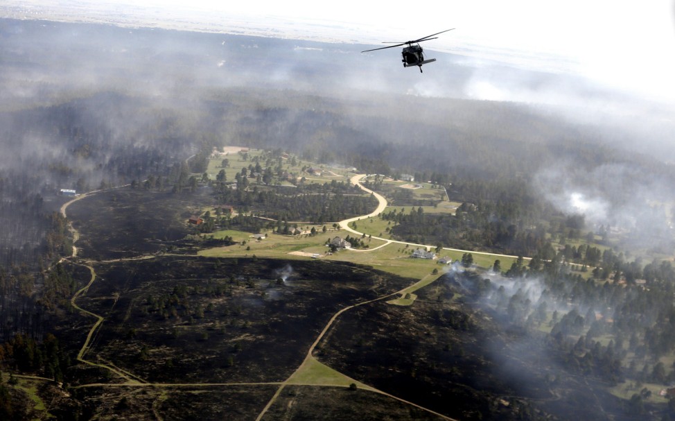 A U.S. Army Blackhawk helicopter patrols over the Black Forest Fire in Black Forest, Colorado