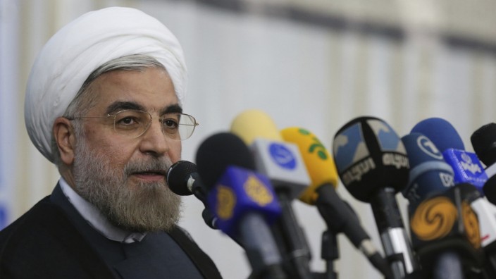 Iranian President-elect Hassan Rohani speaks to the media following a visit to the Khomeini mausoleum in Tehran