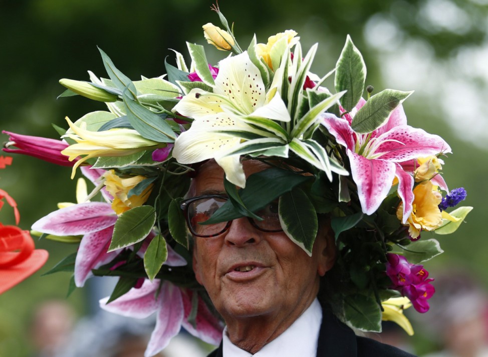 A man wears a hat made of flowers on the first day of the Royal Ascot horse racing festival at Ascot
