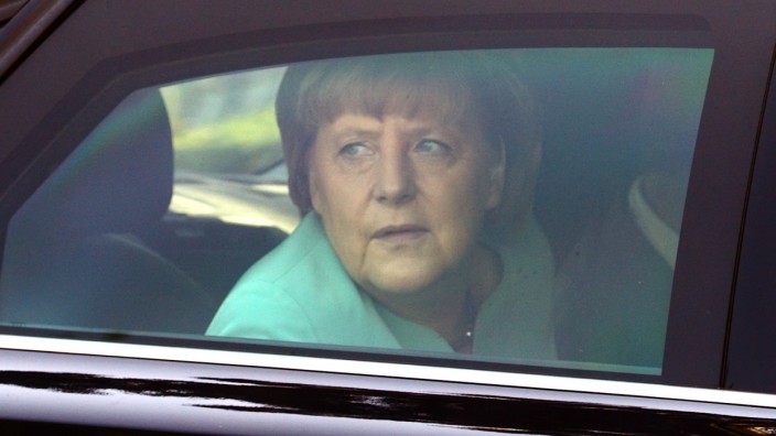 Germany's Chancellor Merkel looks through the window of her limousine as she arrives for a European People's Party EPP leaders' meeting in Vienna