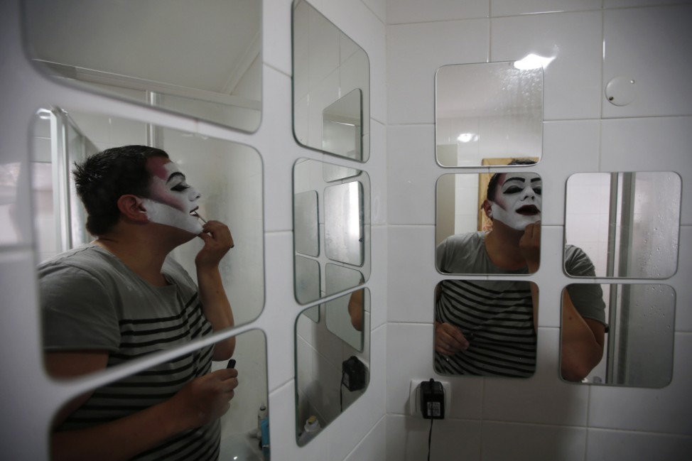 FaraDiva, a drag queen, puts on make-up before participating in the Gay Pride Parade in Lisbon