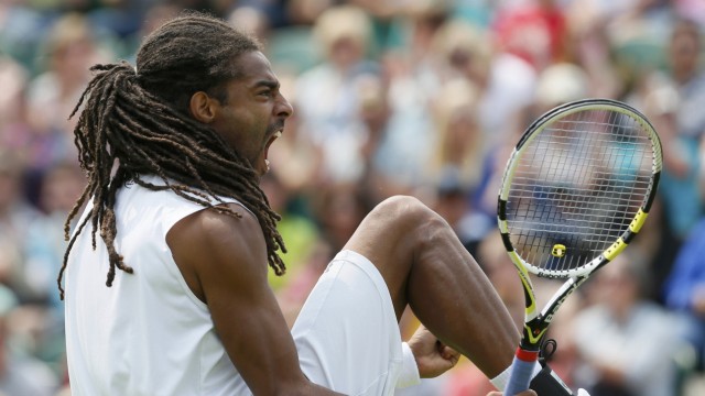 Dustin Brown of Germany reacts during his men's singles tennis match against Lleyton Hewitt of Australia at the Wimbledon Tennis Championships, in London
