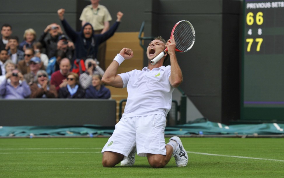Steve Darcis of Belgium celebrates after defeating Rafael Nadal of Spain in their men's singles tennis match at the Wimbledon Tennis Championships, in London