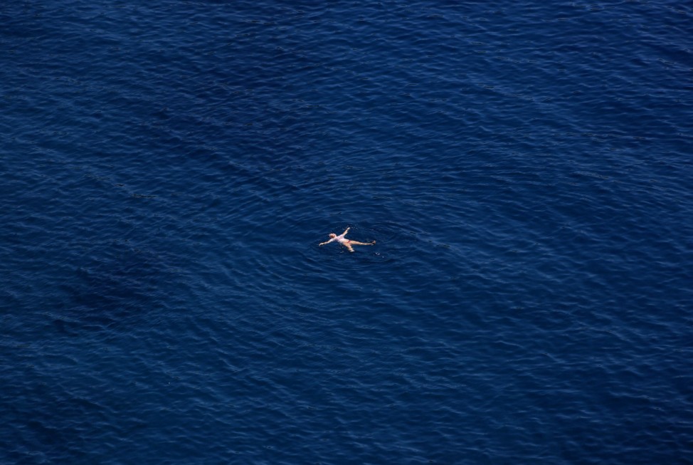 A German tourist bathes in Aegean sea south of Athens