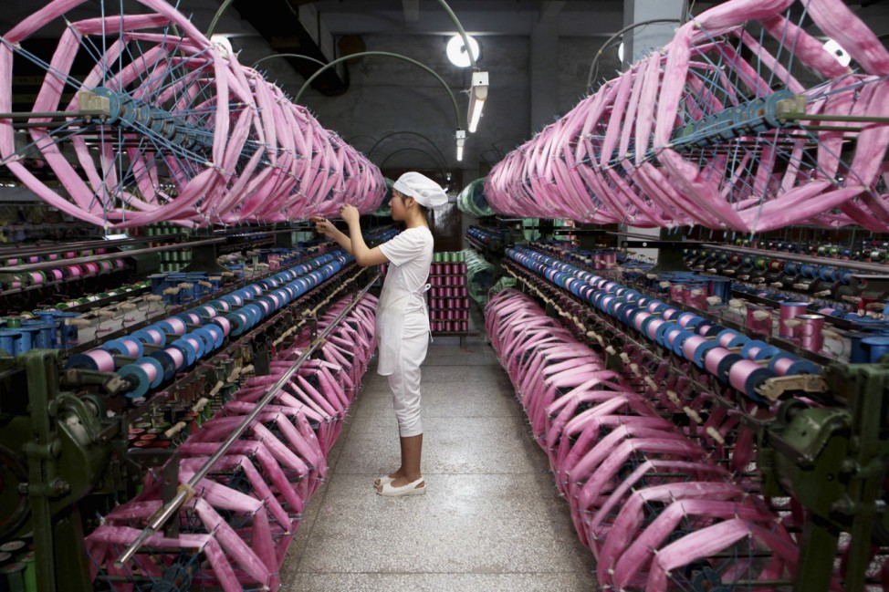 An employee works inside a silk factory in Neijiang