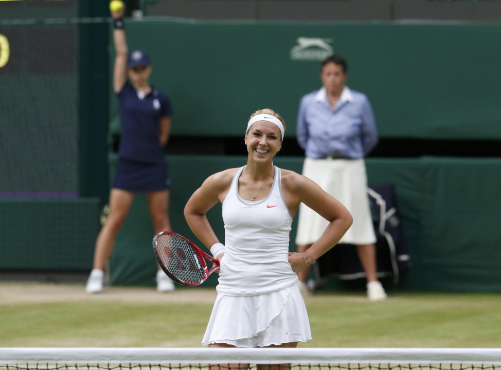 Sabine Lisicki of Germany reacts after missing a shot during her women's semi-final tennis match against Agnieszka Radwanska of Poland at the Wimbledon Tennis Championships, in London