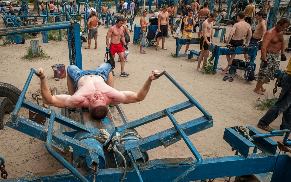 People train at the Kachalka outdoor gym on the banks of river Dniper in Kiev