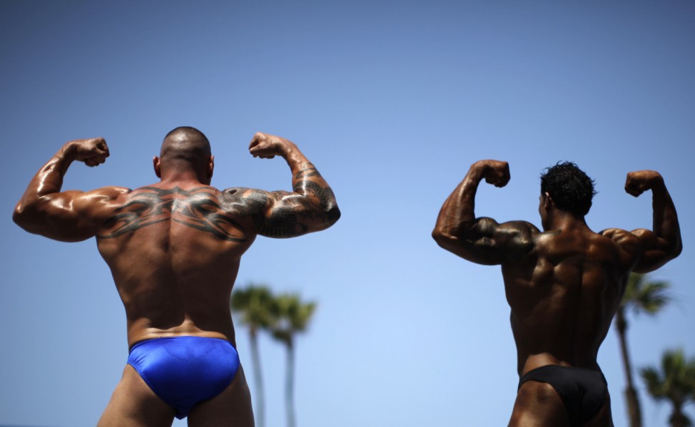 Men compete in the Muscle Beach Independence Day bodybuilding contest on Venice Beach in Los Angeles, California