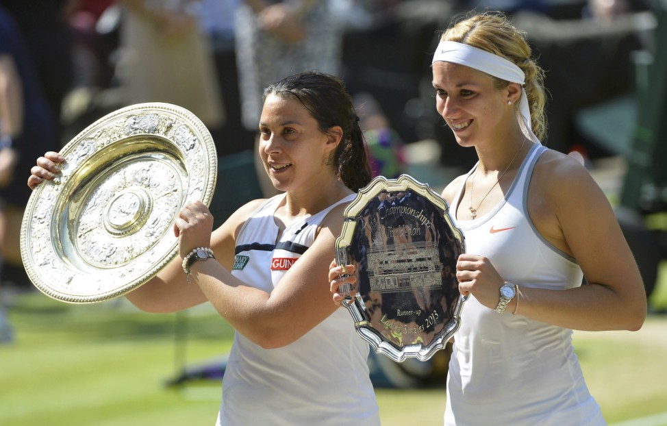 Marion Bartoli of France holds her trophy, the Venus Rosewater Dish, after defeating Sabine Lisicki of Germany in their women's singles final tennis match at the Wimbledon Tennis Championships, in London