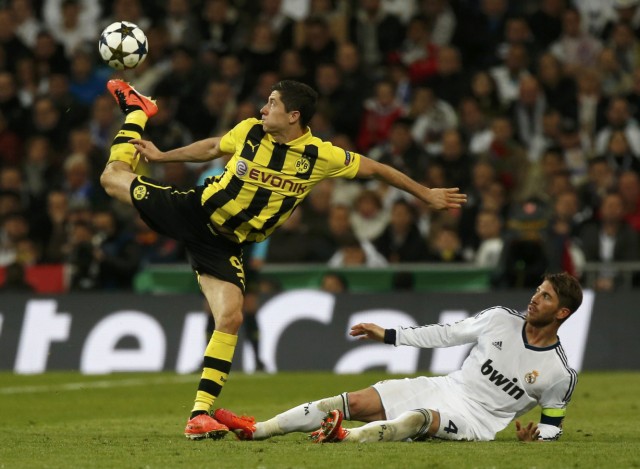 Borussia Dortmund's Robert Lewandowski controls the ball as Real Madrid's Sergio Ramos falls during their Champions League semi-final second leg soccer match in Madrid