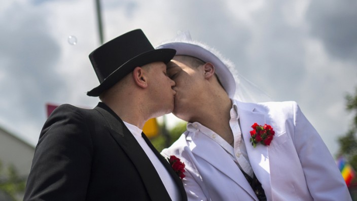 Two men kiss during the Christopher Street Day (CSD) parade in Berlin