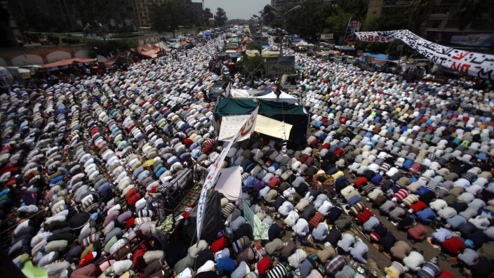 Supporters of ousted President Mohamed Mursi perform the weekly Friday prayers at Rabaa Adawiya square in Cairo