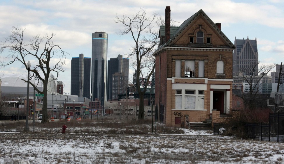 File photo of a vacant, boarded up house in the once thriving Brush Park neighbourhood with the downtown Detroit skyline behind it in Detroit