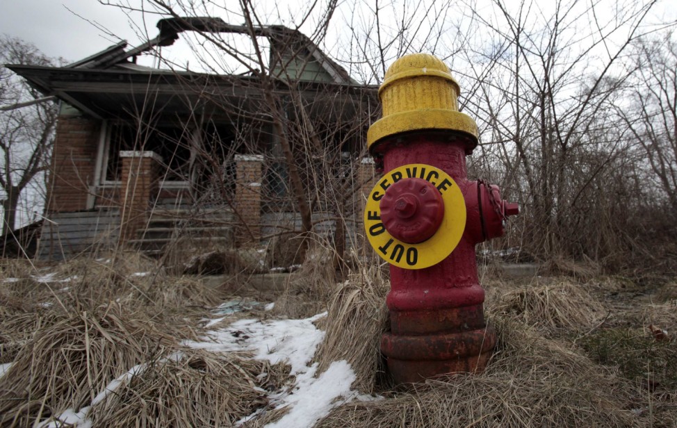 File of a fire hydrant is seen with an 'Out of Service' sign on a blighted street on the east side of Detroit