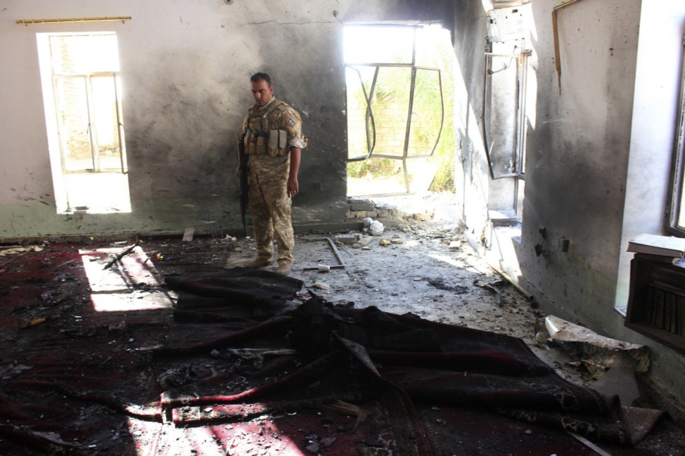 An Iraqi soldier inspects a Sunni mosque at the site of a suicide bomber attack in the town of Wajihiya
