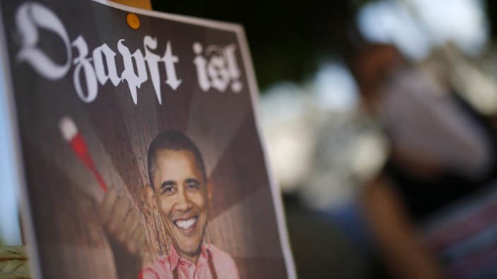 A placard showing U.S. President Obama holding an ethernet cable is seen during demonstration against the NSA in Griesheim