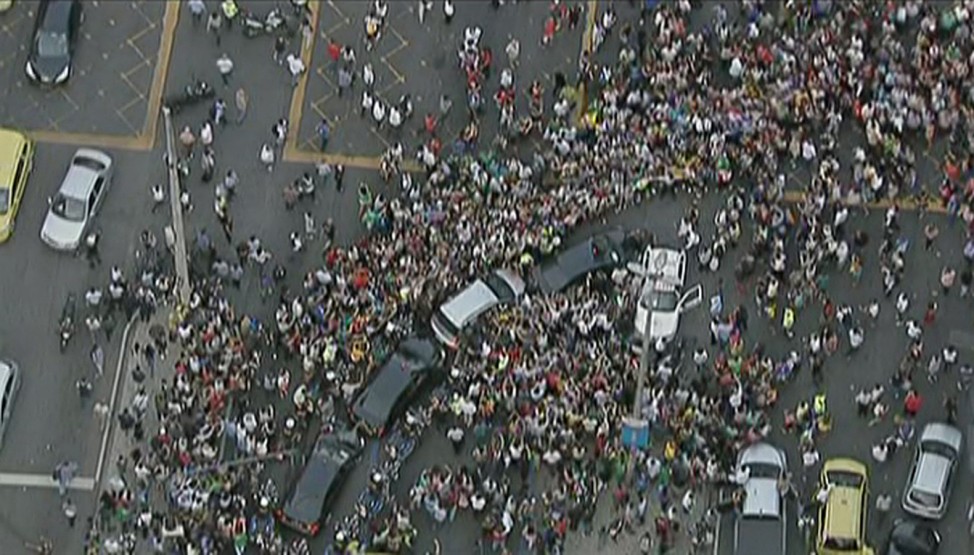 Still image of the car carrying Pope Francis being mobbed by wellwishers as it gets stuck in traffic in downtown Rio de Janeiro