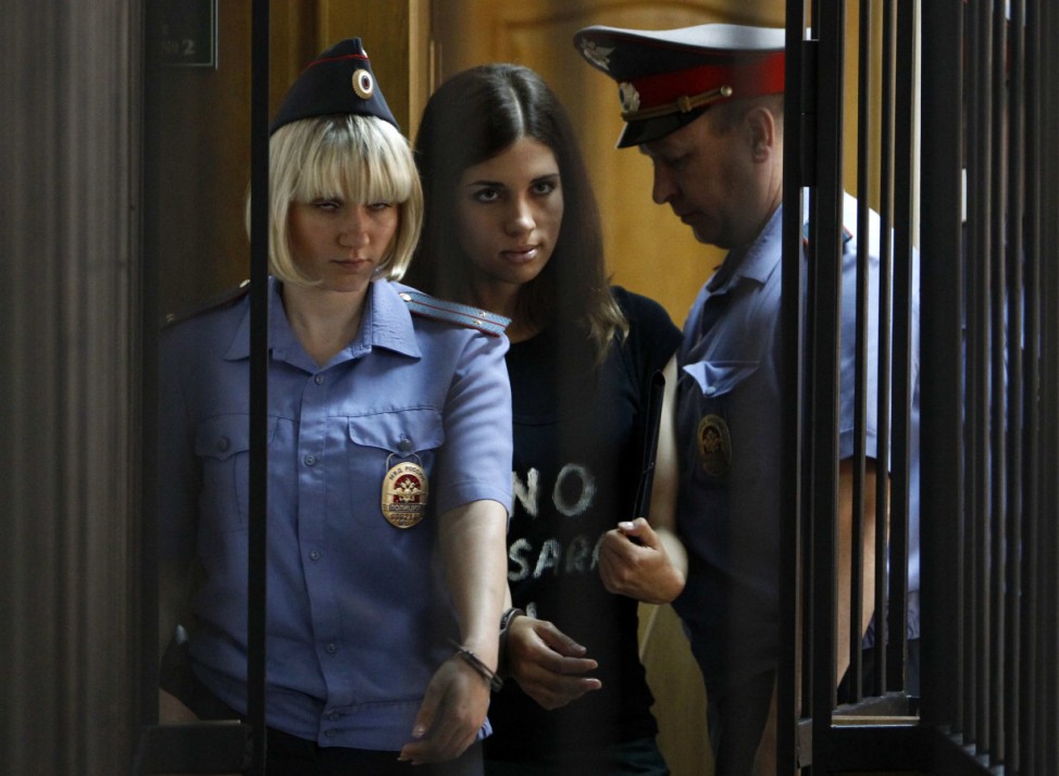 Member of the female punk band 'Pussy Riot' Tolokonnikova is escorted before a court hearing to appeal for parole at the Supreme Court of Mordovia in Saransk