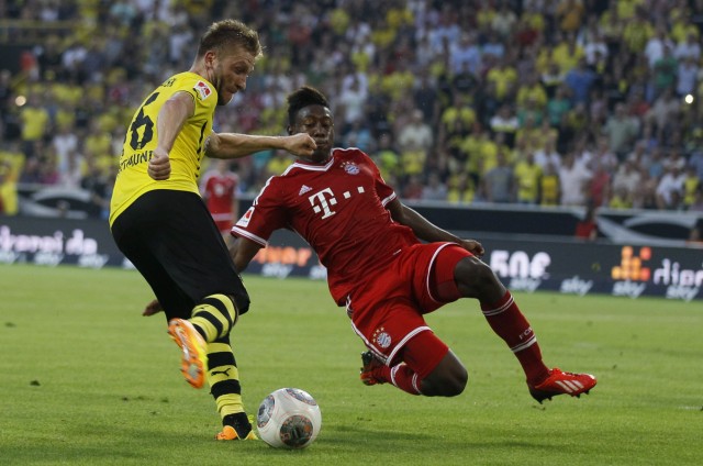 Bayern Munich's David Alaba challenges Borussia Dortmund's Jakub Blaszczykowski during their SuperCup 2013 soccer match in Dortmund