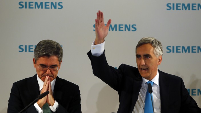 Loescher, chief executive of Siemens AG, and finance chief Kaeser address the media ahead of the company's annual shareholder meeting in Munich