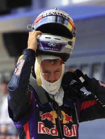 Red Bull Formula One driver Vettel takes off his helmet after the qualifying session of the Hungarian F1 Grand Prix in Mogyorod