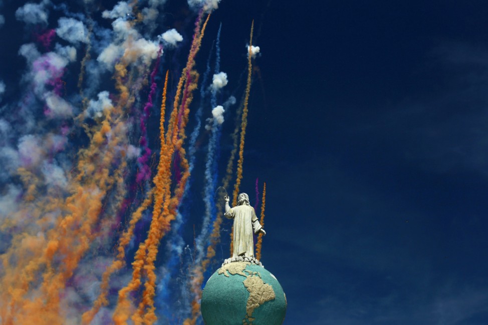 Fireworks are seen behind the Divino Salvador del Mundo monument during 'Agostinas' religious celebrations in San Salvador