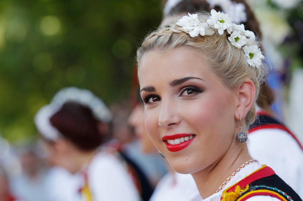 A woman in traditional clothes smiles during the Alka competition in the town of Sinj, southern Croatia