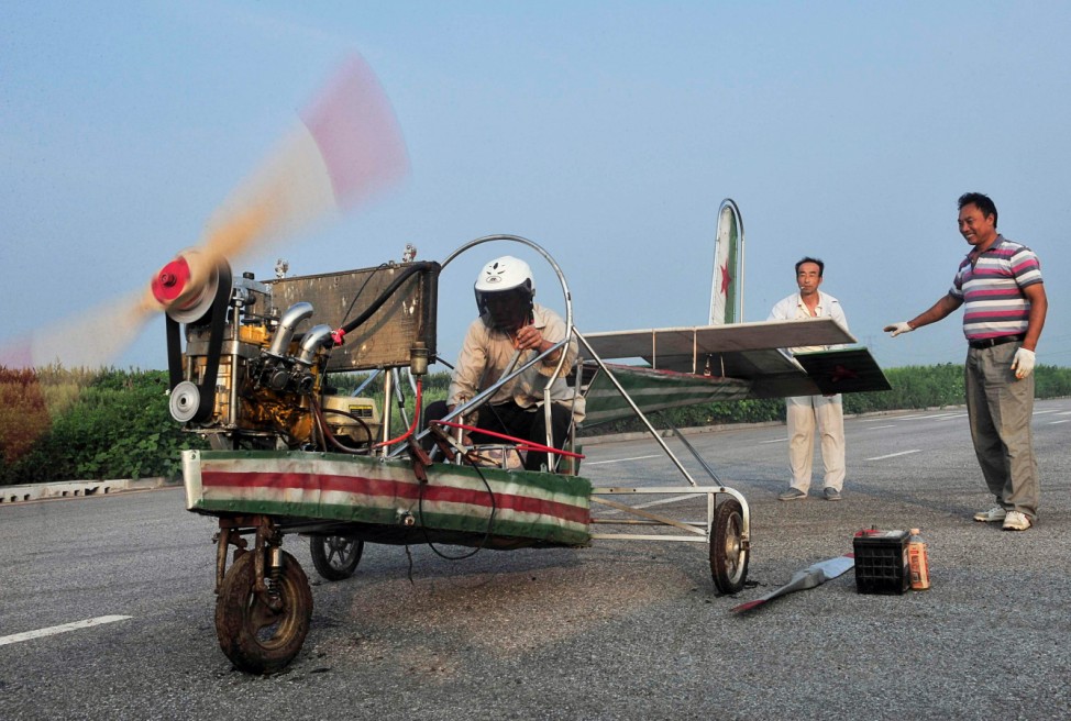 Ding tests the engine of his self-made aircraft before conducting a test flight on the outskirts of Shenyang