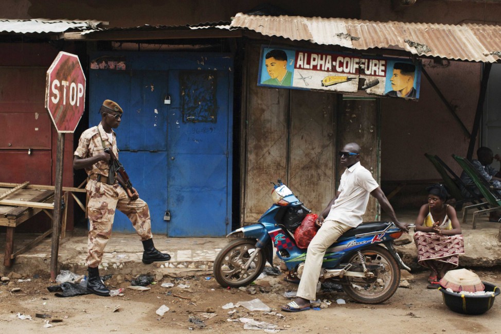 A Malian national guardsman takes up a post along a street outside the Grand Mosque before Eid al-Fitr prayers in Bamako
