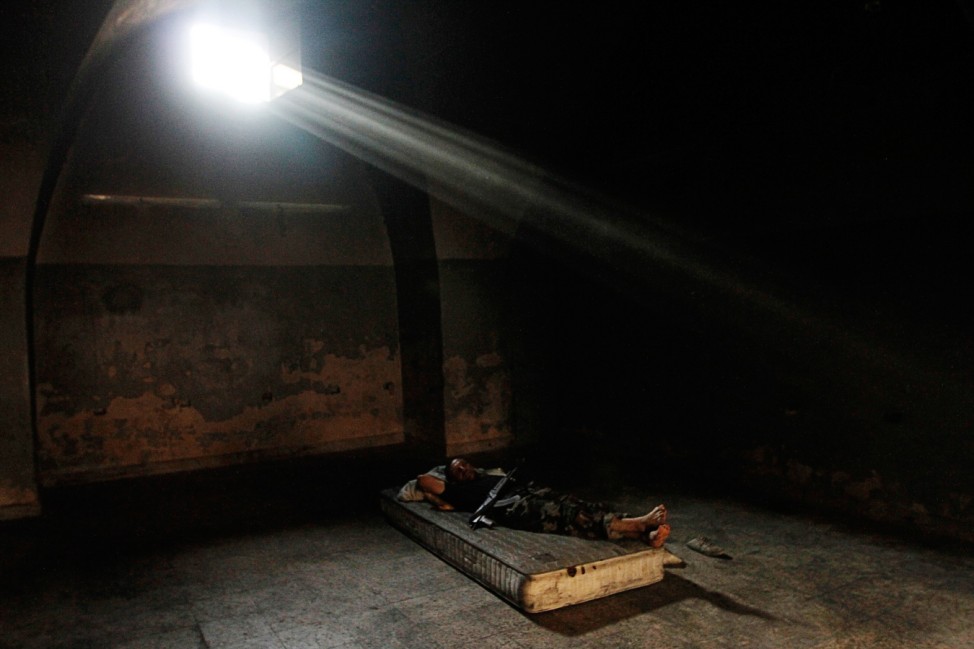A Free Syrian Army fighter sleeps inside a room in Aleppo's Qastal al-Harami neighborhood