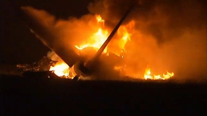 Flames rise from a UPS Airbus A300 cargo plane which crashed near the airport in Birmingham in this still image from video