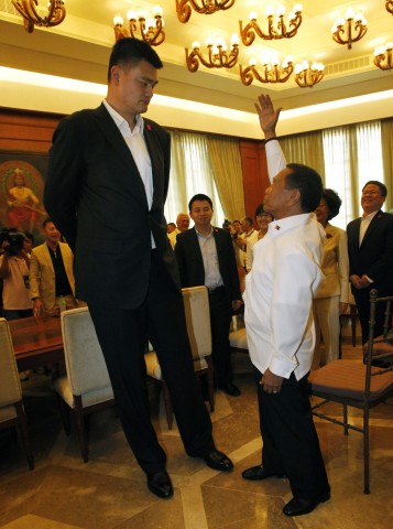 Philippines' Vice President Binay gestures as he talks to Yao during a visit to the Coconut Palace in Manila