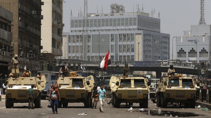Soldiers stand guard on armoured personnel carrier positioned outside Ramses Square, near al-Fath mosque in Cairo