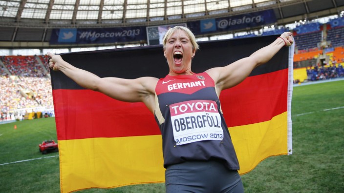 Obergfoll of Germany celebrates with her national flag after winning the women's javelin throw final during the IAAF World Athletics Championships at the Luzhniki stadium in Moscow