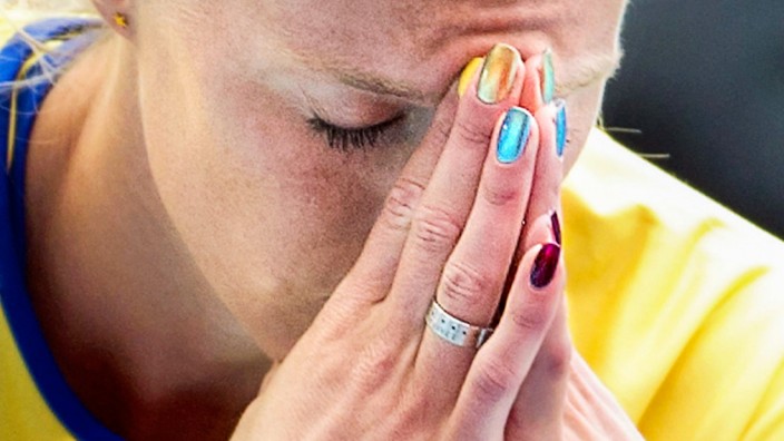 Sweden's Green-Tregaro sits, with her fingernails painted in different colours, during women's high jump qualification heats at IAAF World Athletics Championships in Moscow