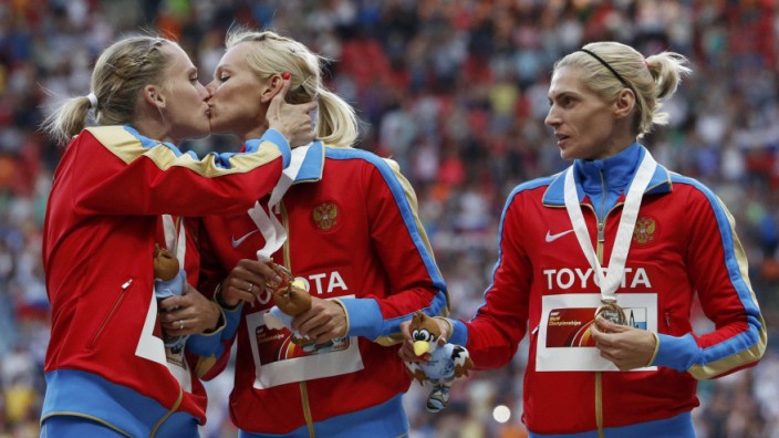 Gold medallists team Russia celebrate at the women's 4x400 metres relay victory ceremony during the IAAF World Athletics Championships at the Luzhniki stadium in Moscow