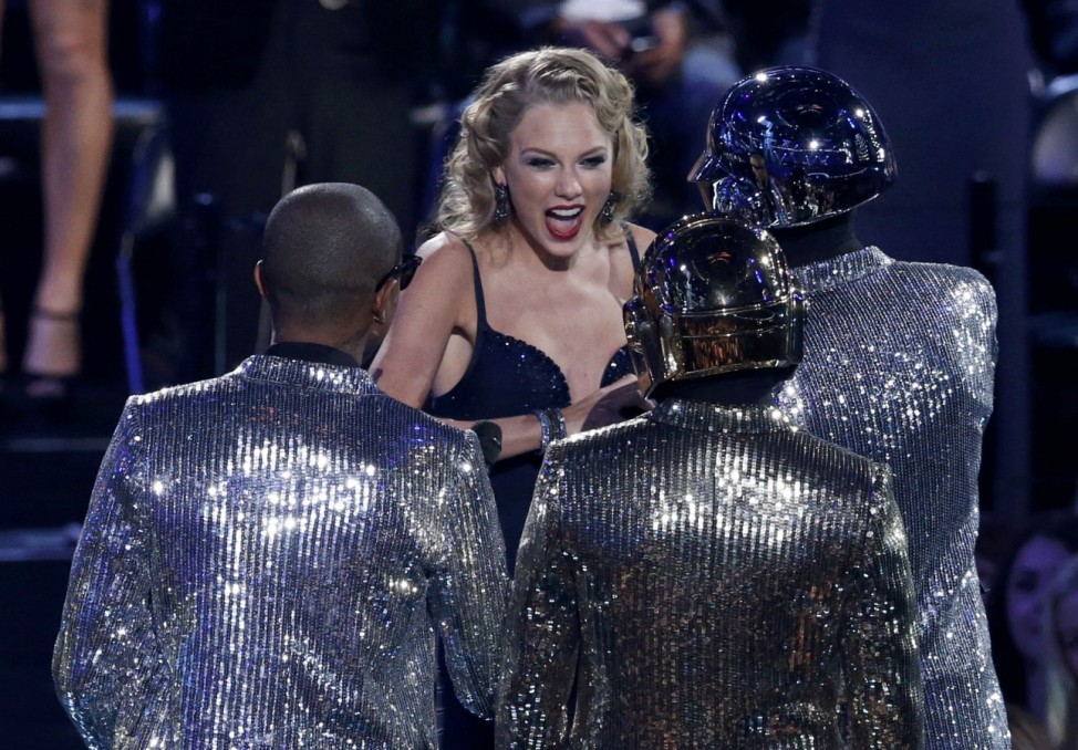 Swift accepts the award for best female video for 'I Knew You Were Trouble' from presenters Daft Punk and Williams during the 2013 MTV Video Music Awards in New York