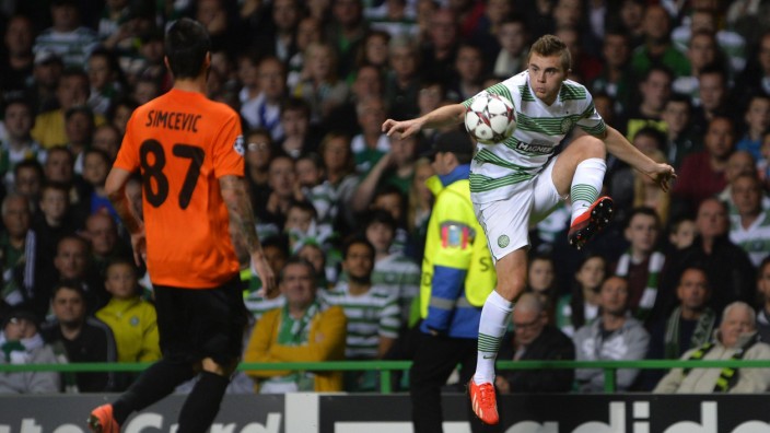 Shakhter Karagandy's Simcevic challenges Celtic's Forrest during their Champions League soccer match in Glasgow