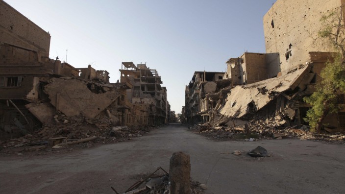 A view of a damaged street and buildings in Deir al-Zor