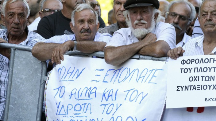 Cypriots protest against austerity measures in a demonstration outside the parliament in Nicosia