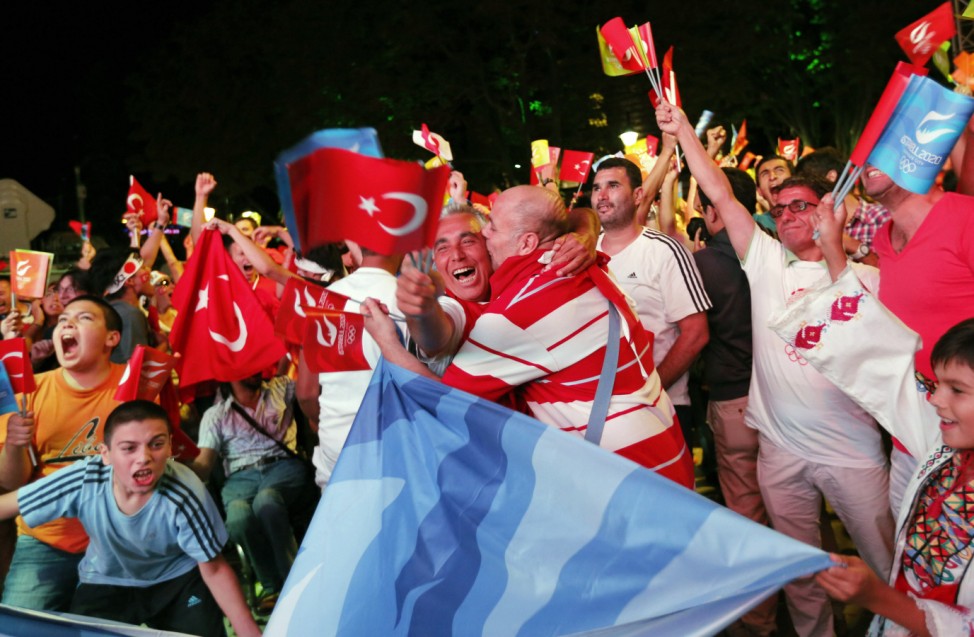 Turks celebrate the results of the opening round of voting for the city will host the 2020 summer Games as they watch it live on big screens in Sultanahmet Square in Istanbul
