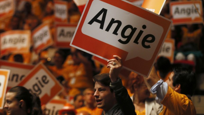 Supporters hold up placards that read 'Angie', the nickname of German Chancellor and conservative CDU leader Merkel, at the CDU's election campaign rally in Duesseldorf