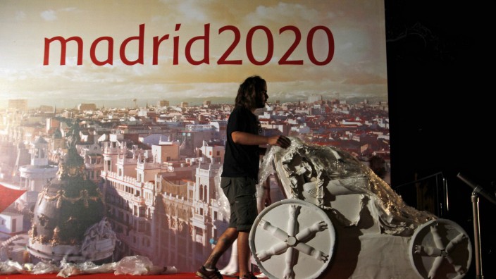 A worker wheels away a replica of a famous Madrid fountain after Madrid was eliminated from the IOC voting for the 2020 Olympic games host city, in Madrid