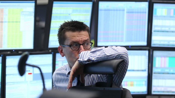 Trader reacts at his desk at the Frankfurt stock exchange