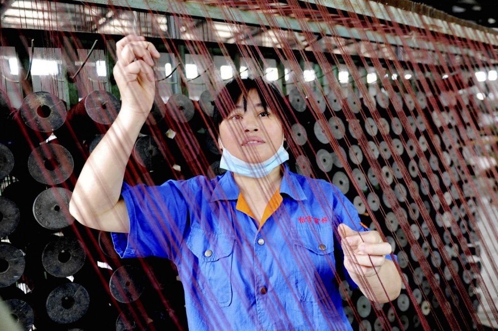 An employee works at a factory in Dexing