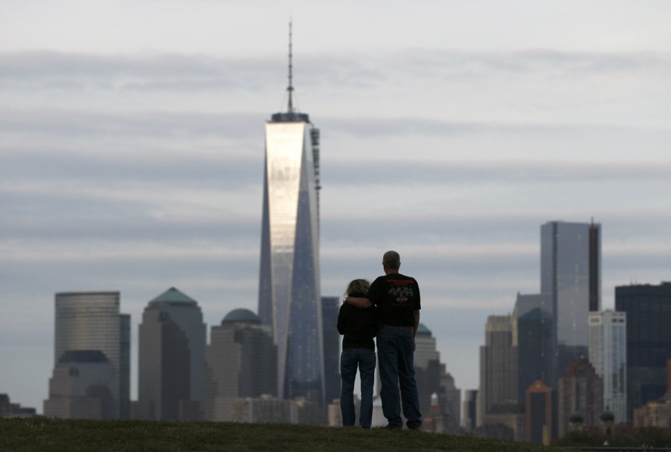 A couple look out at New York's Lower Manhattan and One World Trade Center from Liberty State Park in Jersey City